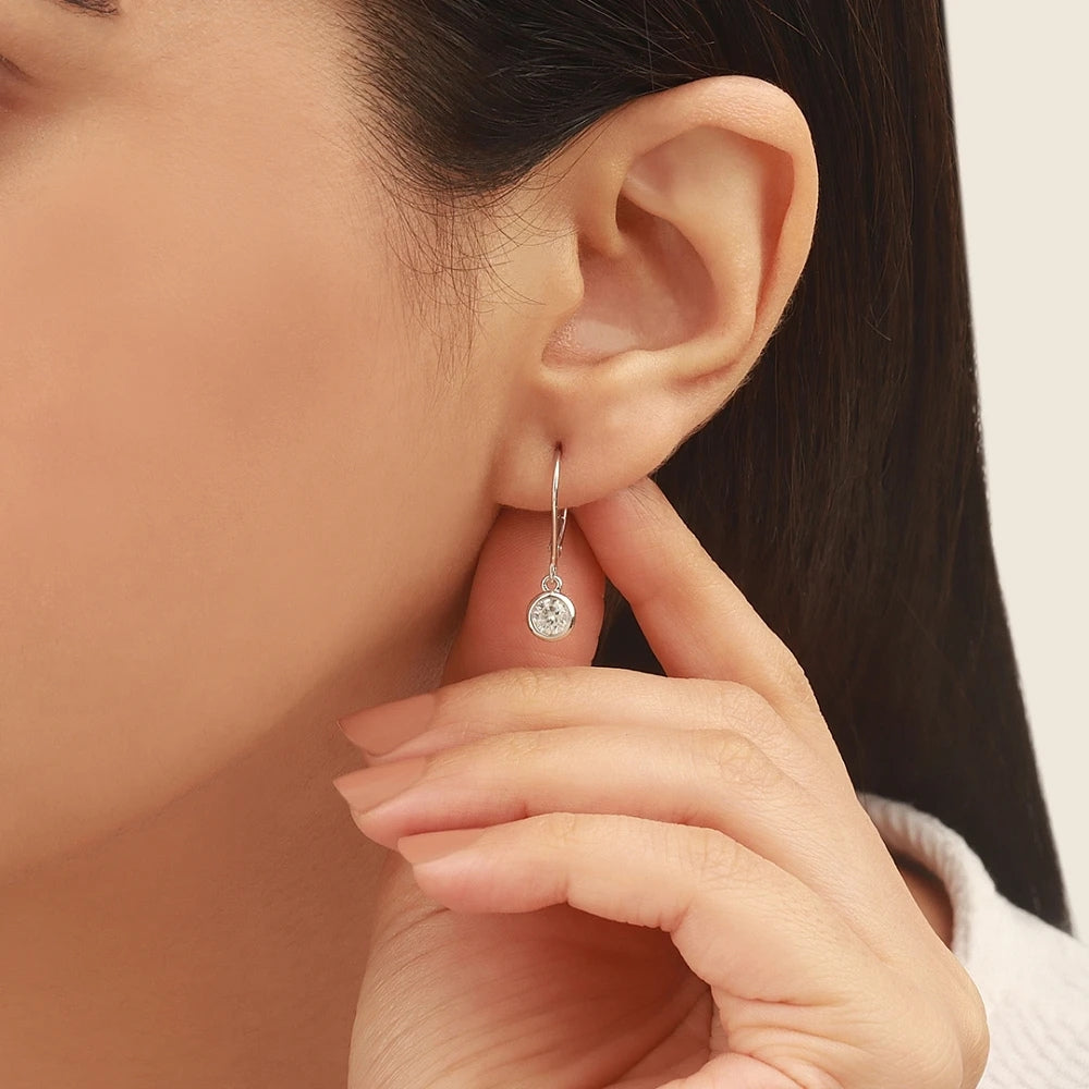 Minimalist Bezel Set Round Moissanite Dangle Earrings In 14K White Gold