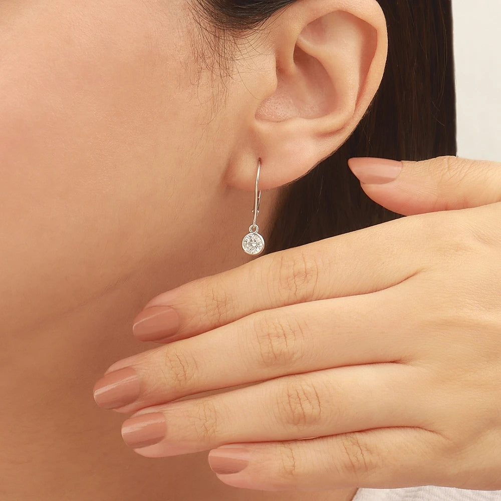 Minimalist Bezel Set Round Moissanite Dangle Earrings In 14K White Gold