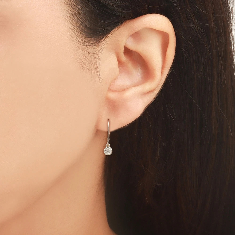Minimalist Bezel Set Round Moissanite Dangle Earrings In 14K White Gold