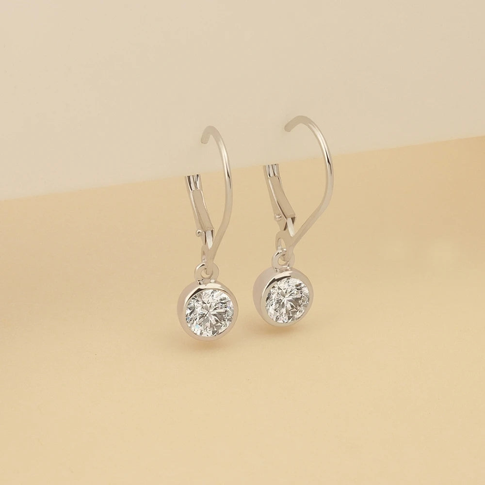 Minimalist Bezel Set Round Moissanite Dangle Earrings In 14K White Gold