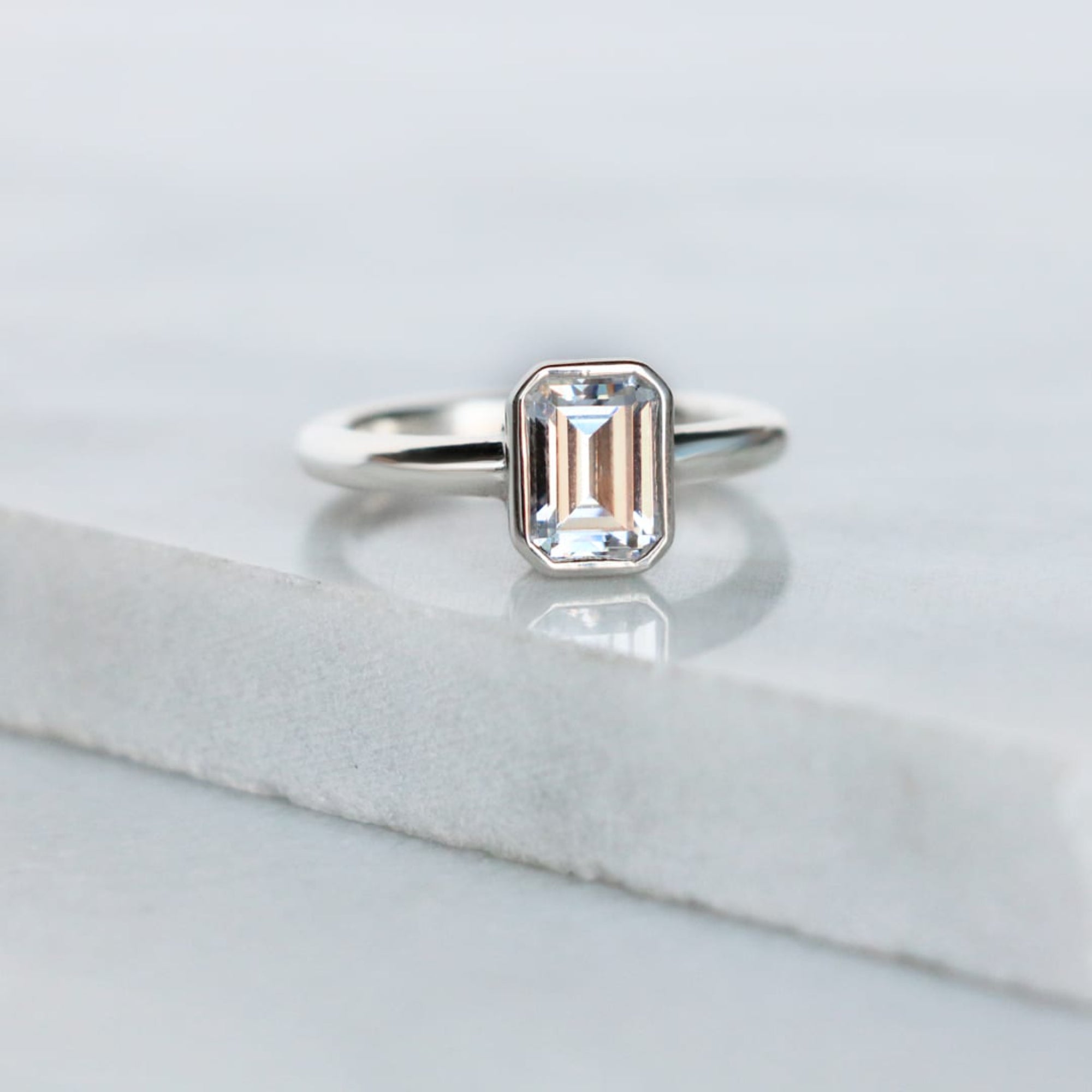 Bezel Set Emerald Cut Solitaire Engagement Rings