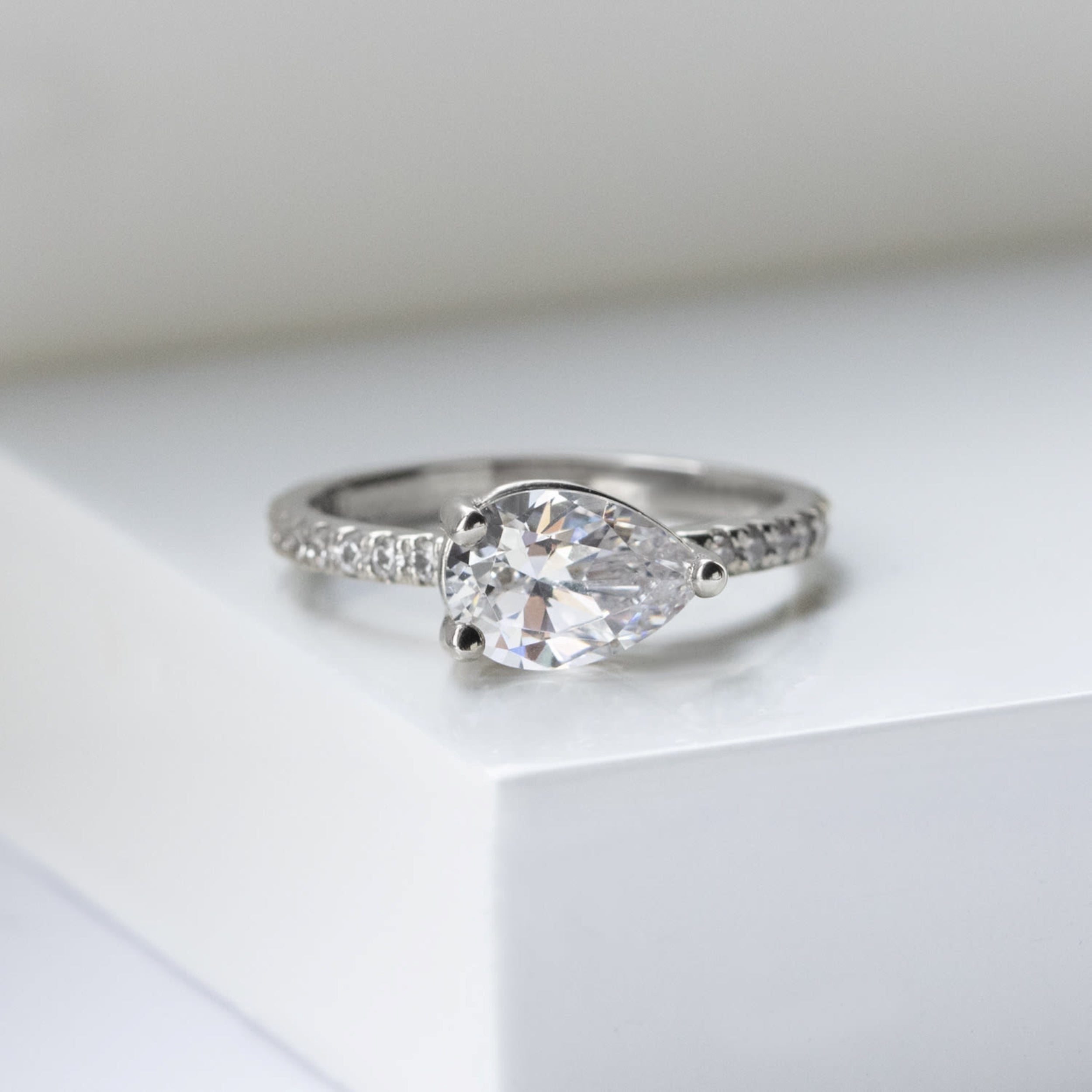 East to West Pear Cut Moissanite Pave Set Ring