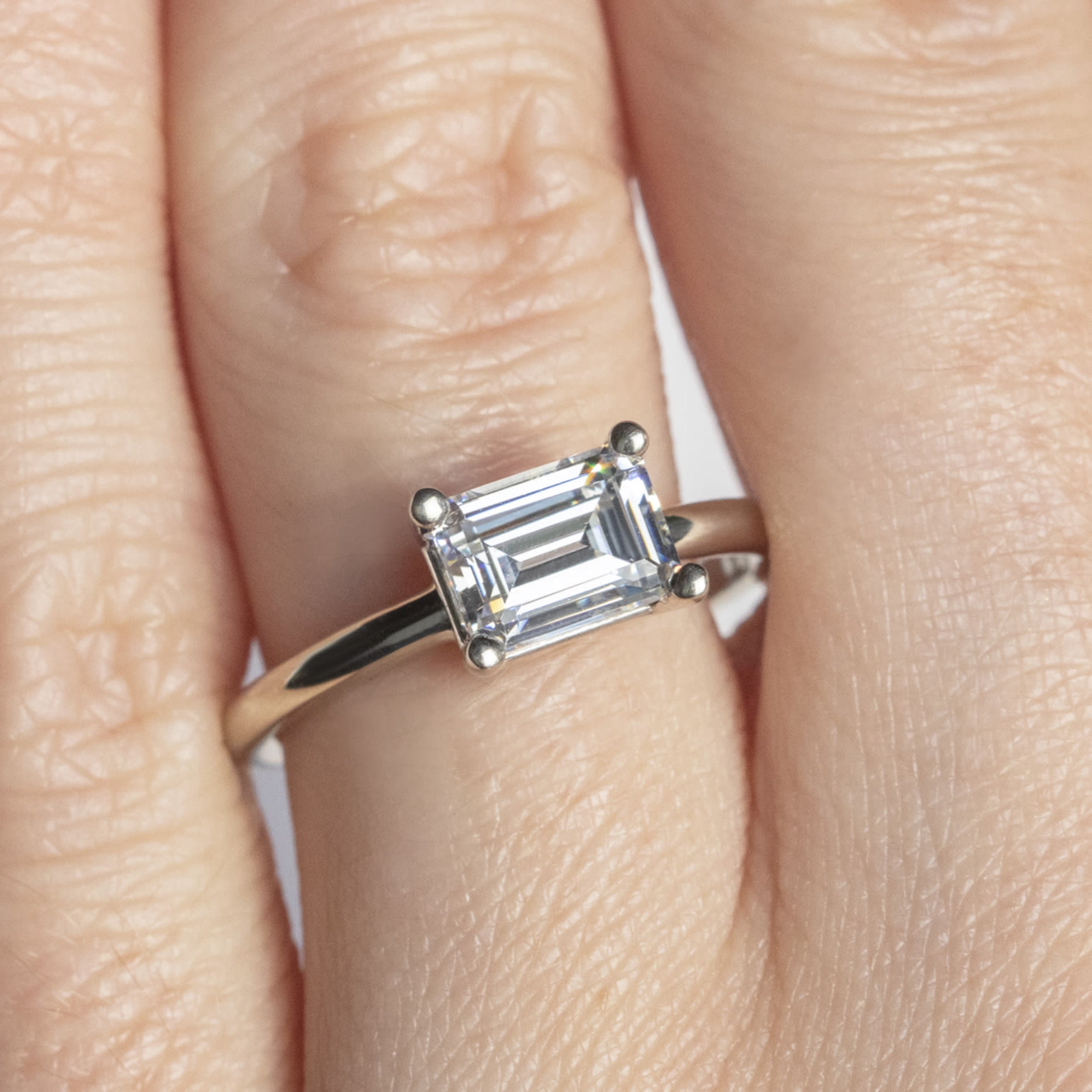 East to West Elegant Basket Emerald Cut Engagement Ring