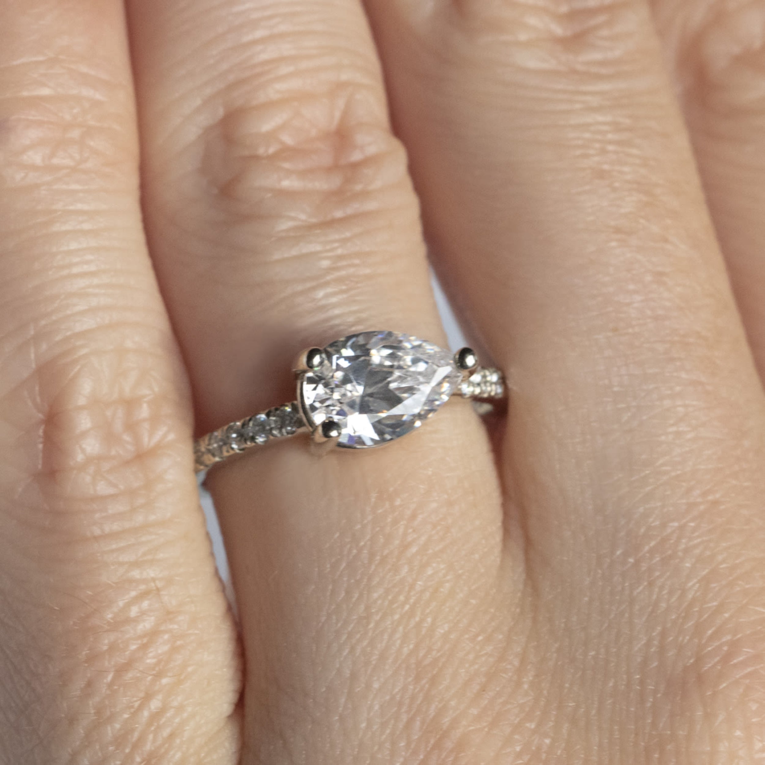 East to West Pear Cut Moissanite Pave Set Ring