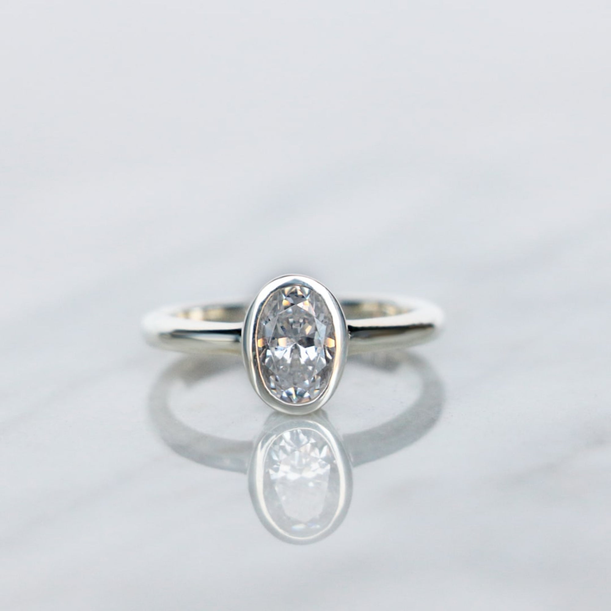 Oval Cut Bezel Set Solitaire Engagement Ring